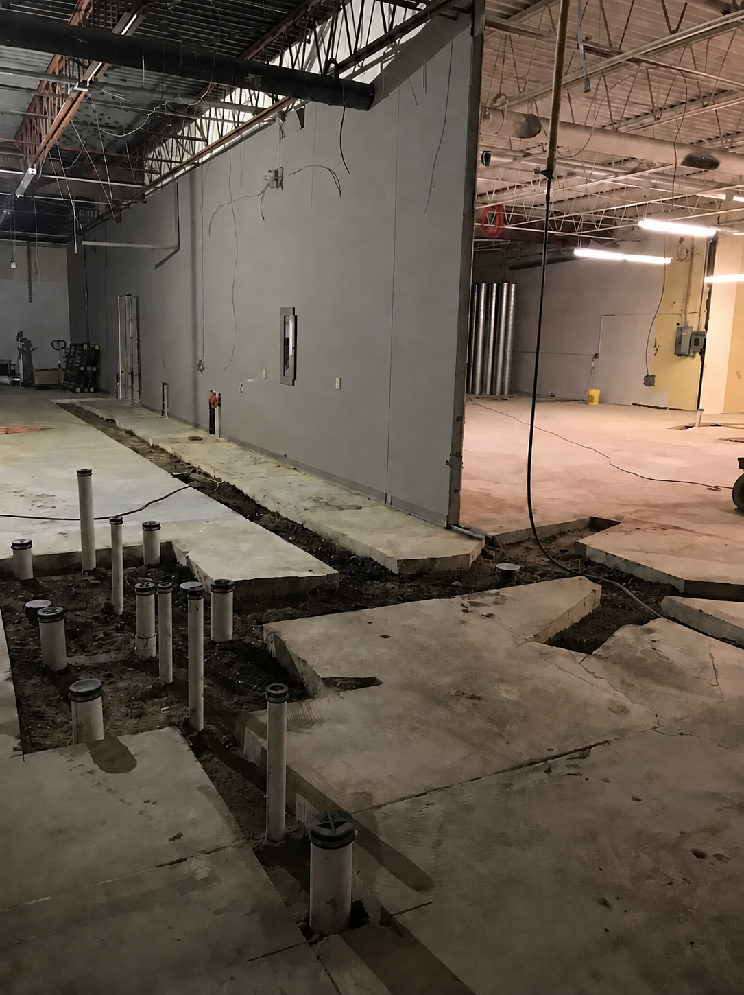 Commercial plumbing pipe stub-ups in a slab-cut installation
